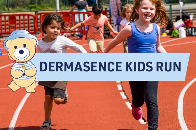 Zwei Kinder rennen fröhlich auf einer roten Laufbahn während des Dermasence Kids Run-Events.