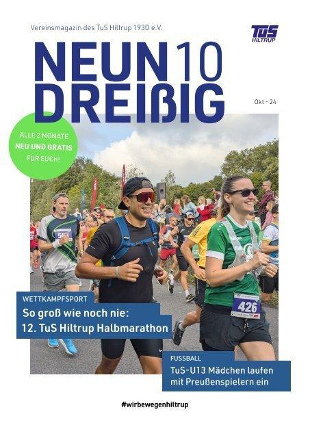 Läufer beim Halmarathon des TuS Hiltrup auf einer belebten Straße, umgeben von Zuschauern und grüner Natur.